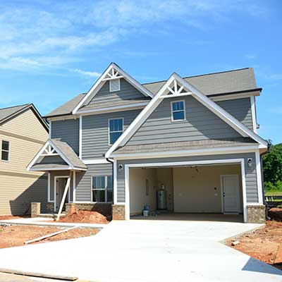 New construction home with new siding and a shingle roof installed